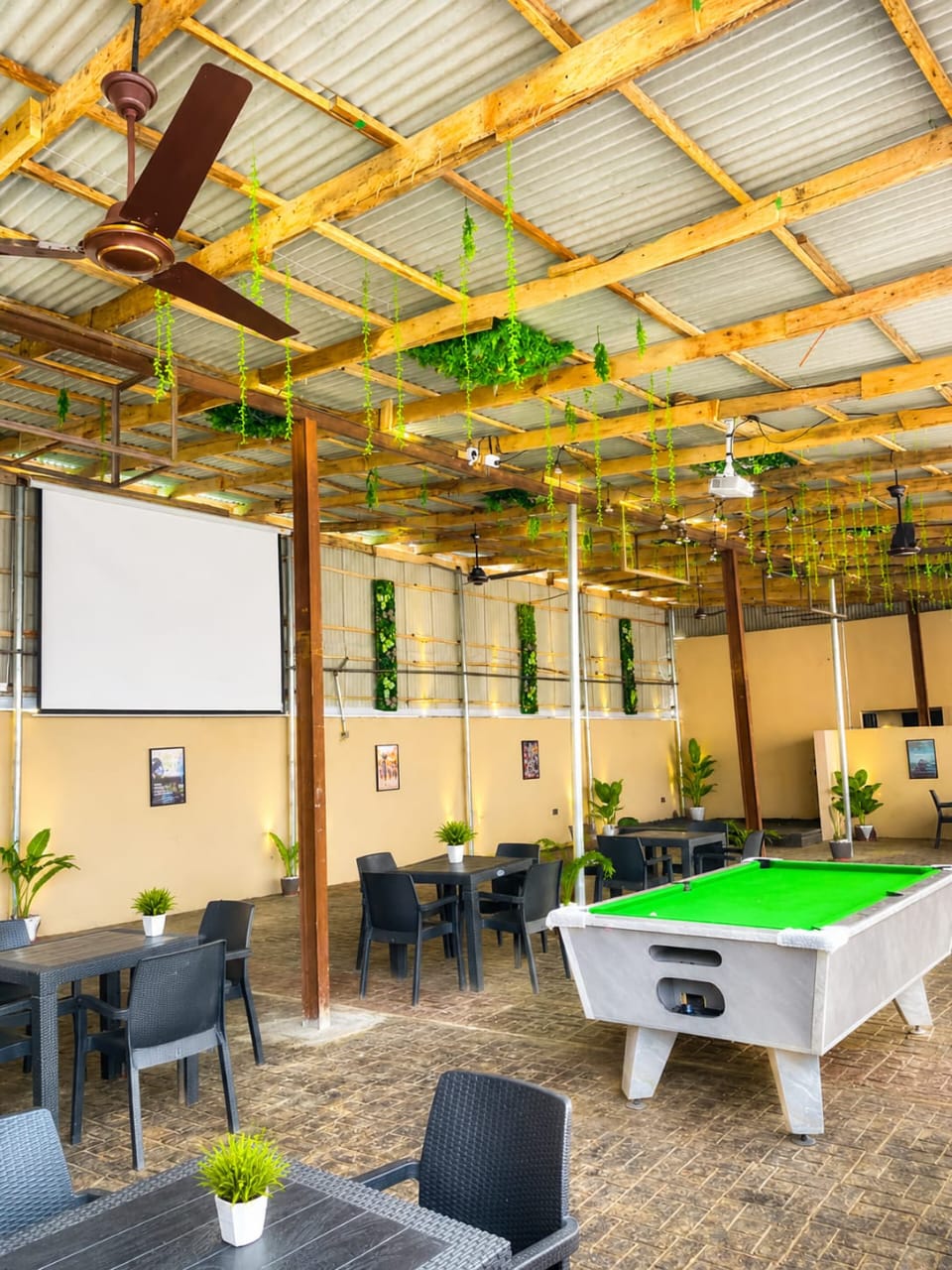 Outdoor lounge and event center with projection screen and pool table